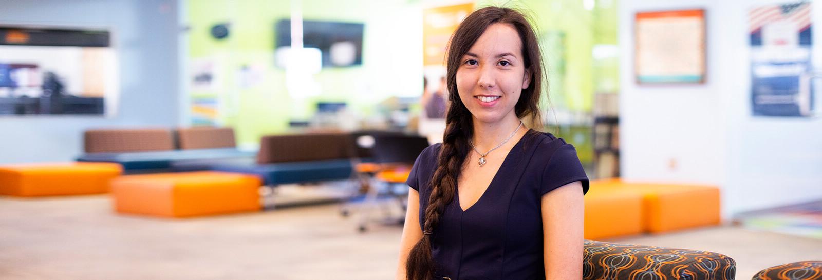 基拉Okuma Poses smiling in Pima's Northwest Campus Student Life Center